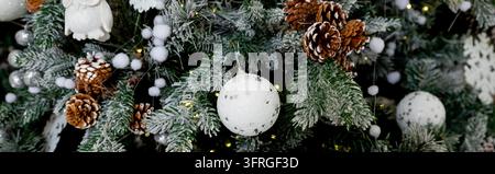 Christmas tree with silver and white balls. Christmas card with white silver decor. Christmas tree decoration with tinsel, glitter balls and a Stock Photo