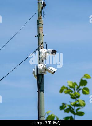 Two Outdoor Surveillance Cameras Mounted on a Utility Pole Stock Photo