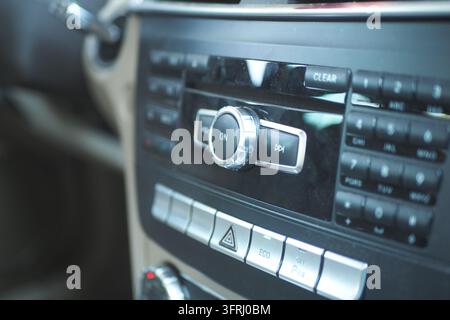 Dashboard of a car featuring various stereo controls and buttons for operation Stock Photo