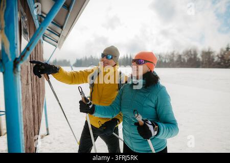 Mature couple taking a break during cross country skiing day in nature. Stock Photo
