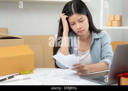 Debt business, Stressed and headache business asian woman analysis financial company problem. no money to pay, shortage, Financial problems, mortgage, Stock Photo