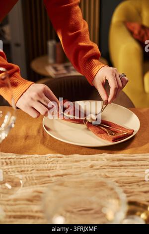 Woman Decorating Festive Dinner Table with Cutlery for Celebration Stock Photo