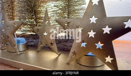gold stars with candles, christmas decor on wood, banner, concept of home, holiday marketing Stock Photo