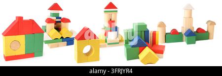 Bright buildings from toy wooden cubes isolated on white, collage - Colorful wooden blocks arranged in playful house and tower shapes. Bright primary Stock Photo