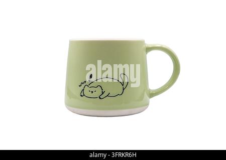 A green ceramic mug with a cute cat design on a white background. Stock Photo