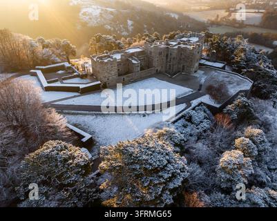 Sunrise over snow covered Castle Drogo on a chill winter morning, Dartmoor National Park, Devon, England.  Winter (December) 2023. Stock Photo