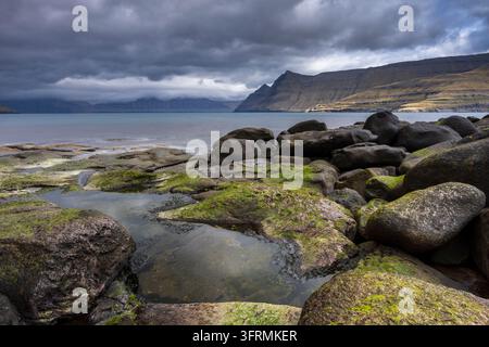 The rocky shores of Funningsfjordur in the Faroe Islands, Denmark, Europe.  Spring (April) 2026. Stock Photo