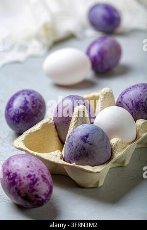 Naturally colored eggs prepared for Easter. Happy Easter card. Naturally colored Easter eggs lying in the tray, selective focus Stock Photo