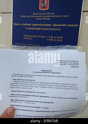 MOSCOW - APR 11, 2019: Piece of paper with foreign writing on it. Moscow prefecture, receiving requests for a rally meeting picket. The paper is being held by a person Stock Photo