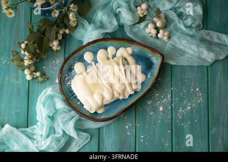 Bowl of fresh cottage cheese with sour cream and sugar, in blue oval bowl with grainy cottage cheese on wooden turquoise, view Stock Photo