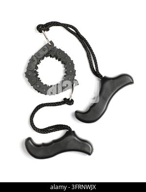 Black portable chainsaw with handles isolated on white background. Black and white composition. Hand tool for tourism and camping Stock Photo