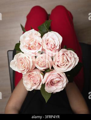 Women hands holding bouquet of beautiful pink roses. View of mountains Stock Photo
