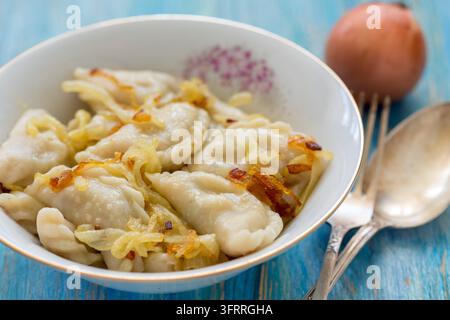 Dumplings with fried onions in a white bowl Stock Photo