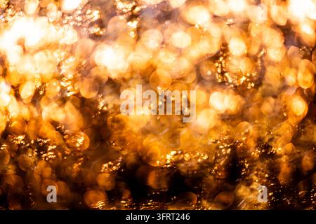 Golden premium background in nano texture. Golden shimmering texture on metallic surface. Golden abstract gold backdrop for branding. Golden glowing Stock Photo