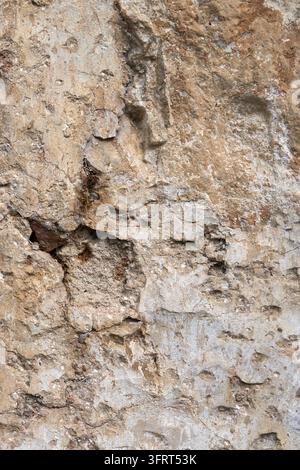 Rough Beige Stone Wall Texture Background with Weathered Rustic Concrete Surface Stock Photo
