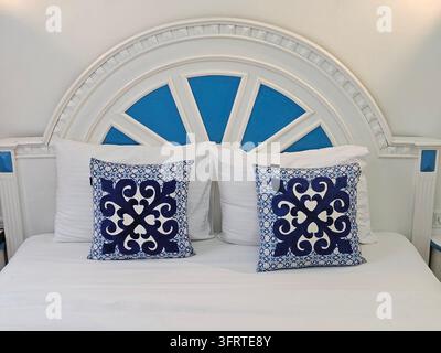 ISTANBUL - SEP 28, 2025: Bed with two pillows, one of which is blue and white. The pillows are arranged neatly and the bed is made. The blue and white color scheme gives the bed a calm Stock Photo