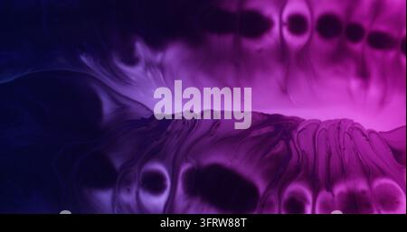 Paint spill. Spatter texture. Blur purple blue neon color paper water round droplets blotch spreading on abstract creative background. Stock Photo