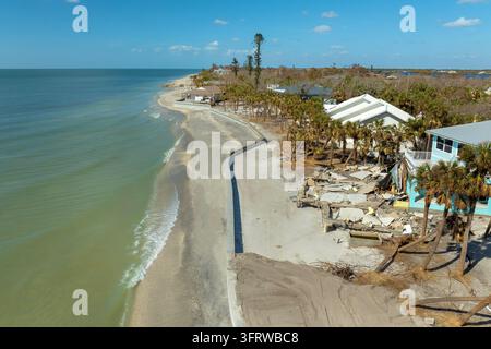Ruined buildings in need of demolition or repair. Storm surge water and wind damaged houses roof and collapsed walls after hurricane in Florida Stock Photo