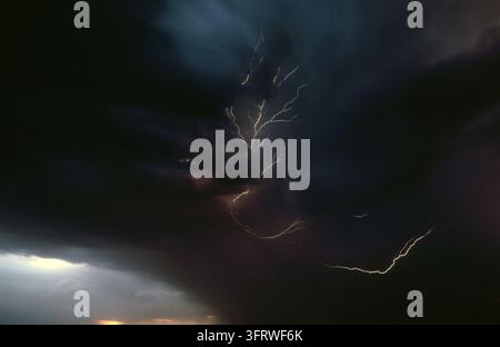 DARK STORM CLOUDS AND LIGHTNING FLASHES OVER THE REMOTE TANAMI DESERT IN THE NORTHERN TERRITORY, AUSTRALIA. Stock Photo