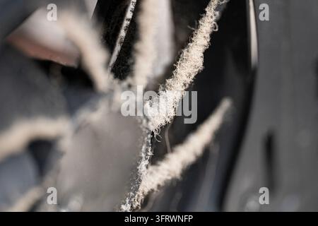 Close-up of a heavily dusty computer cooling fan with dirty blades covered in lint and dust, illustrating PC maintenance, cleaning and hardware overhe Stock Photo