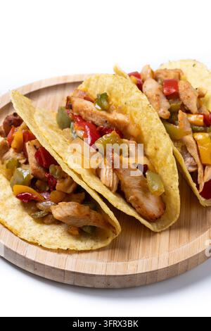 Crispy Mexican chicken tacos with colorful vegetables on white background Stock Photo