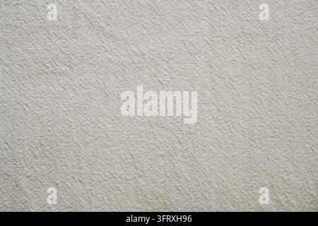 Neutral oatmeal colored cotton fabric with a fine woven texture and soft natural appearance. Stock Photo