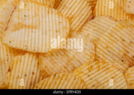 Lots of potato chips, texture close up Stock Photo
