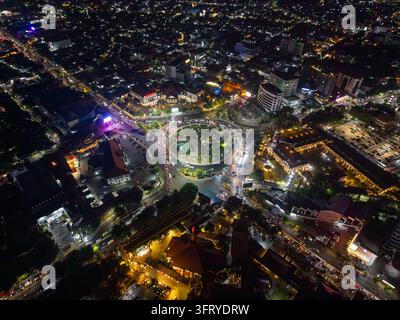Aerial view of Simpang Lima Semarang at night, showing the illuminated roundabout, surrounding city lights, traffic, and urban infrastructure in Kecam Stock Photo