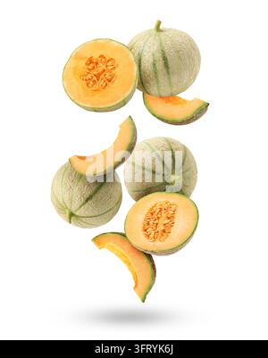 Fresh cantaloupe melons falling on white background. Whole and sliced Stock Photo