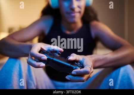 Woman Playing Online Video Games with Gamepad and Headphones Stock Photo