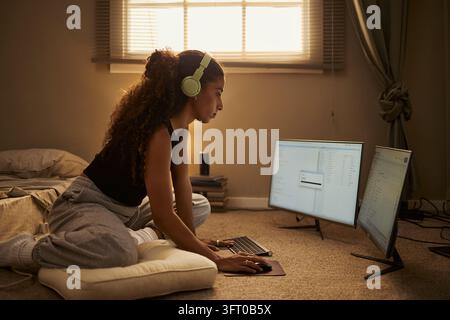 Biracial Woman Working on Computer from Floor at Home Stock Photo
