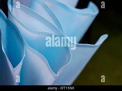Closed up photo of a blue umbrella folds with rain drops on Stock Photo