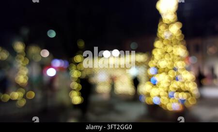 Christmas tree bokeh background with blurred golden festive light Stock Photo