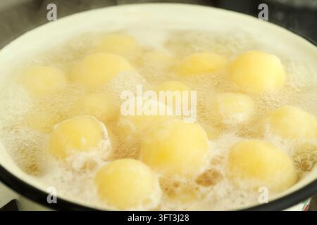 Concept of cooking with boiled young potatoes Stock Photo - Alamy