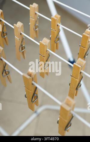 Clothespins hanging on drying rack, close up Stock Photo