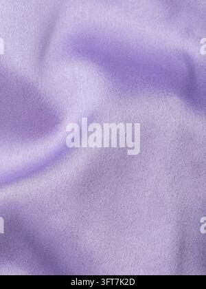 Macro texture of lilac silk fabric with soft folds and satin sheen, delicate textile background filling full frame Stock Photo