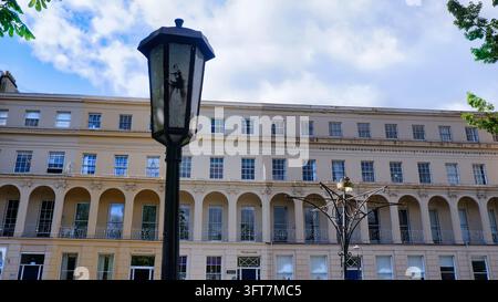 A retro style street lamp stands near a decorative post outside a beautiful Regency period town house terrace in Cheltenham, England, taken on 17 Apri Stock Photo