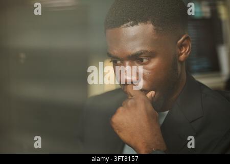 Focused Black Man Working on Computer in Cybersecurity Office Stock Photo