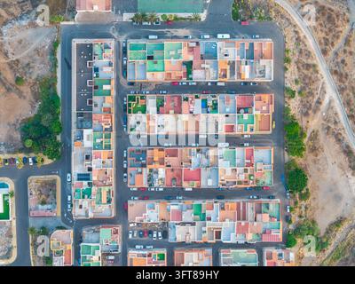 Aerial view of residential blocks with colorful rooftops, paved streets, and parked cars in Santa Cruz de Tenerife, Canary Islands, Spain. Stock Photo