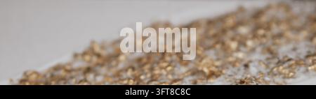 Abstract blurred perspective view of golden foil particles on white plaster surface for luxury decorative backdrop stock photo layout. Stock Photo