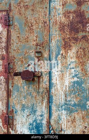 Hinges welded on to the door of a rusting metal structure Stock Photo