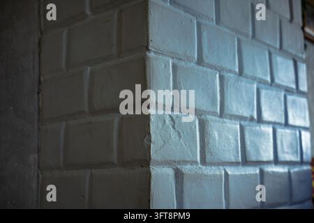 White painted brick wall surface showing rectangular masonry blocks with grout lines. Stock Photo