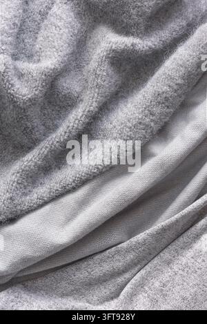 Various gray knitted fabrics, soft and warm cashmere or woolen textures of knitwear for autumn and winter. Hygge and cosy home concept design. Stock Photo