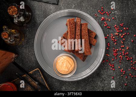 Garlic rye bread croutons with sauce Stock Photo