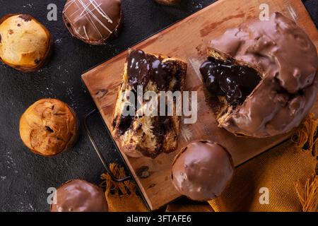Overhead shot of a traditional Christmas panettone or chocotone coated in milk chocolate and sliced open to reveal a generous, gooey dark chocolate tr Stock Photo