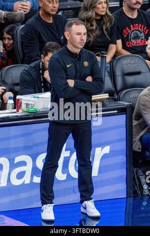 Denver Nuggets head coach David Adelman checks the overhead scoreboard ...
