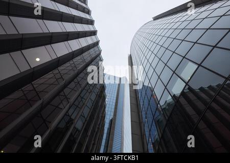 Upward perspective of corporate glass skyscrapers and office buildings in financial district Stock Photo