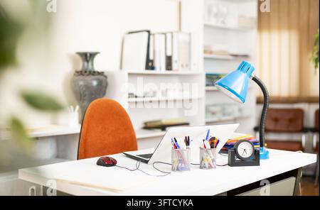 Comfortable workplace desk for businessman with laptop in white modern office interior Stock Photo