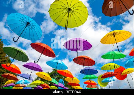 Сolorful hanging umbrellas against blue sky as  decoration Stock Photo