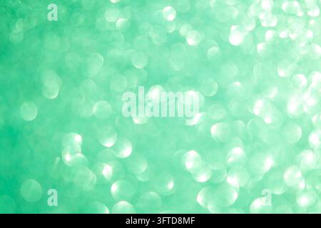 Soft green bokeh lights abstract background with sparkling turquoise highlights and dreamy glow Stock Photo